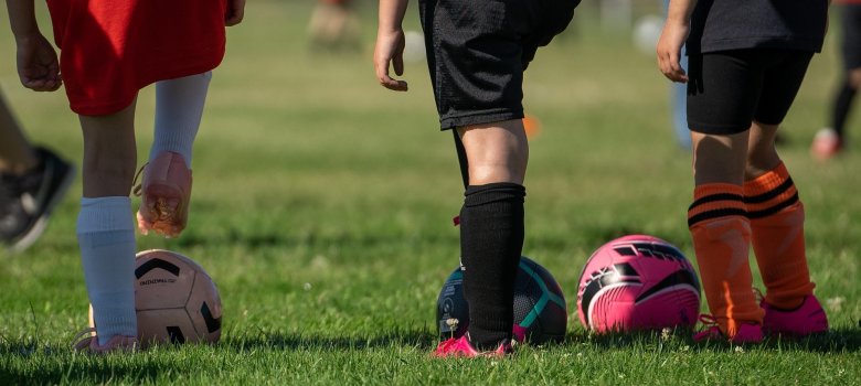 Spielfeld mit spielbereiten und wartenden  Kindern